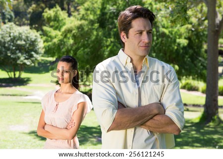Couple not talking after a dispute in the park on a sunny day