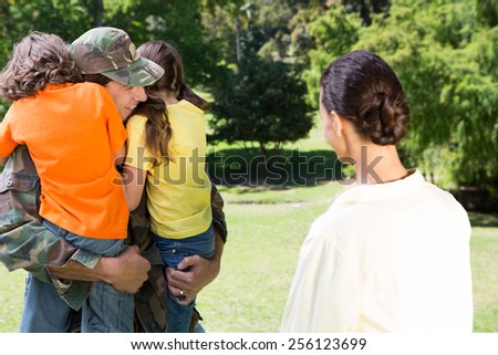 Handsome soldier reunited with family on a sunny day