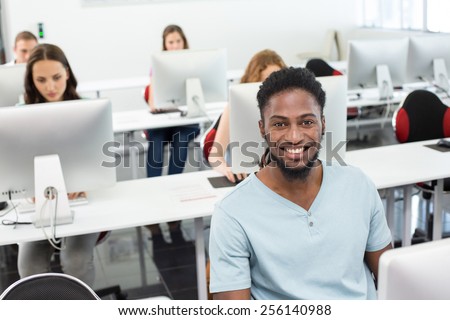 Portrait of smiling students in computer class