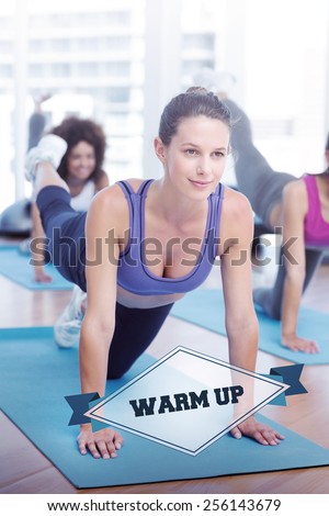 The word warm up and women doing stretching exercises in fitness studio against badge