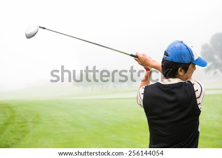 Golfer teeing off at the golf course