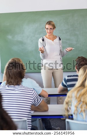 Female teacher teaching students in the class