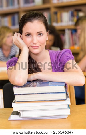Portrait of female student sitting in the library