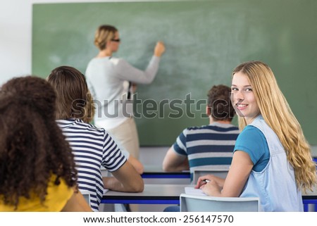 Female teacher teaching students in the class