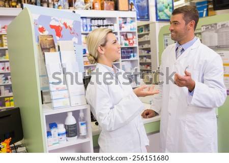 Cheerful team of pharmacist talking together in the pharmacy