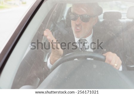 Nervous man sitting at the wheel in his car