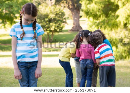 Little girl feeling left out in park on a sunny day
