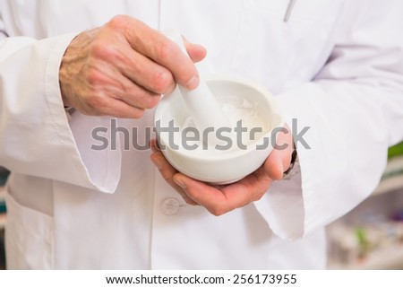 Close up of pharmacist mixing medicine in the pharmacy