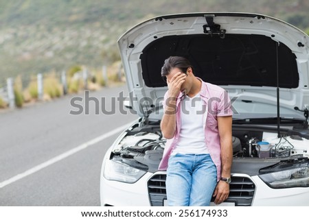 Desperate man after a car breakdown at the side of the road