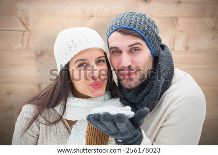 Young winter couple against bleached wooden planks background