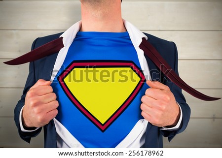 Businessman opening shirt in superhero style against bleached wooden planks background