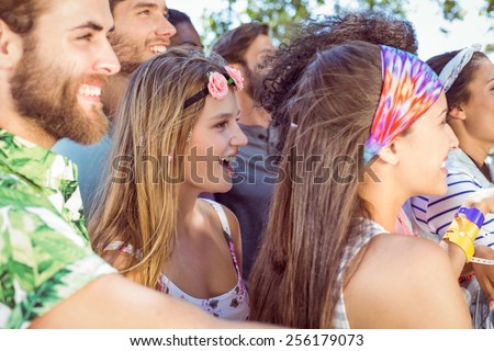 Happy hipsters listening to live music at a music festival