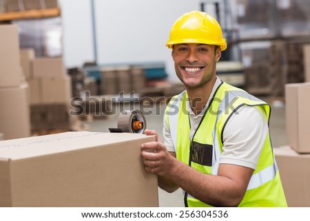 Worker in warehouse preparing goods for dispatch