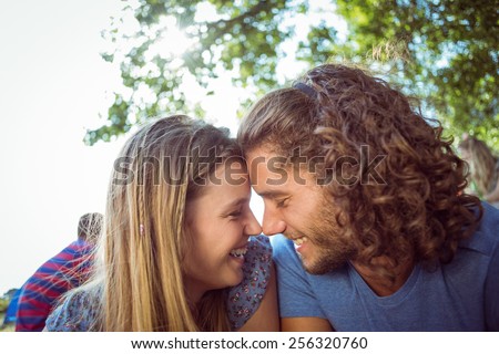 Hipster couple smiling at each other at a music festival