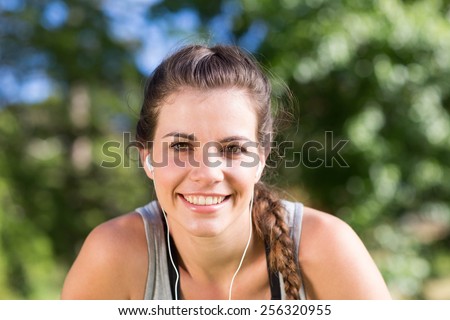 Fit brunette on a run in the park on a sunny day