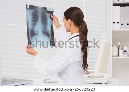 Focus doctor analyzing xray results in examination room