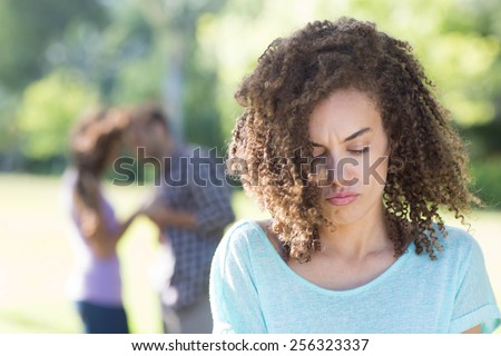 Woman upset at her crush with other girl on a sunny day