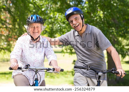 Happy senior couple on their bike on a sunny day