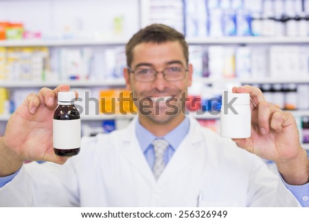 Pharmacist showing medicines jar at the hospital pharmacy