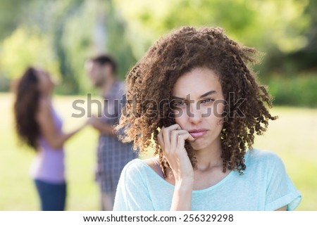 Woman upset at her crush with other girl on a sunny day