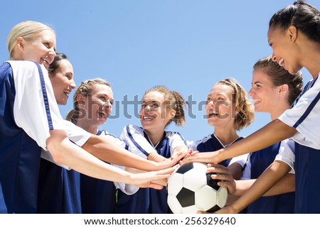 Pretty football players celebrating their win on a sunny day