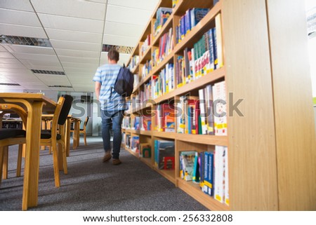 Student walking away in the library at the university
