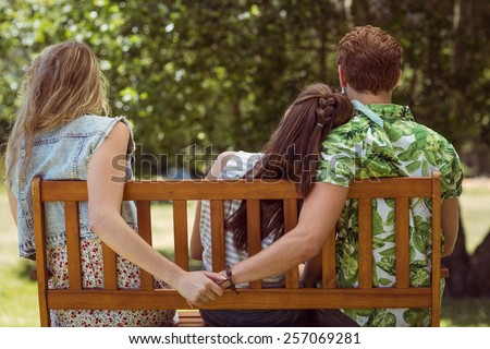 Young man holding hand of wrong girl on a summers day