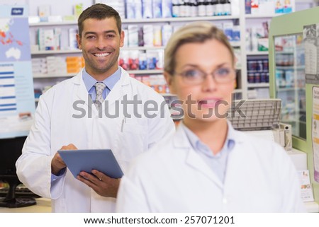pharmacists looking at camera at hospital pharmacy