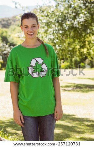 Environmental activist smiling at camera in the park on a sunny day
