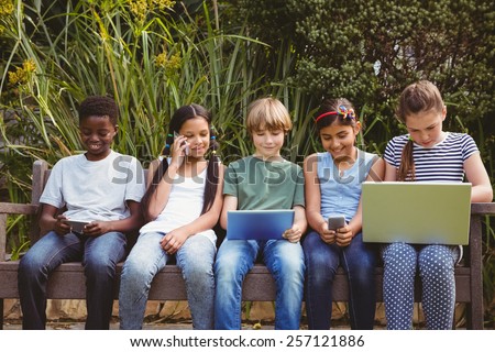 View of children using technologies at the park
