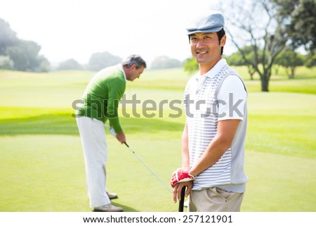 Golfing friends on the putting green at the golf course