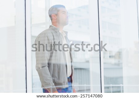 Side view of thoughtful businessman looking thought window