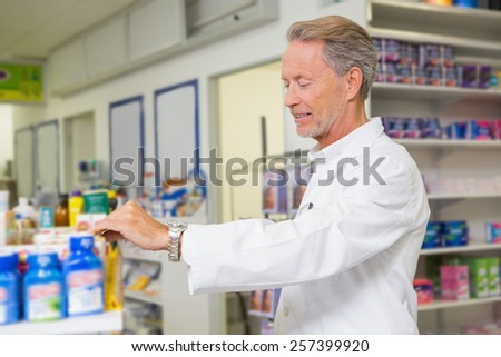 Senior pharmacist looking at medicine in the pharmacy