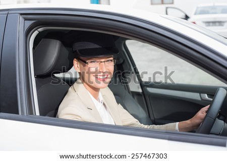 Chauffeur smiling at camera in the car
