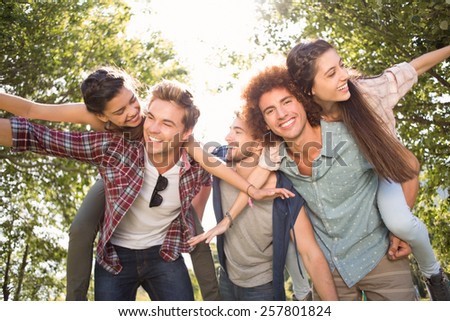 Happy friends in the park taking selfie on a sunny day