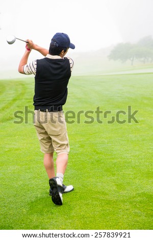 Golfer teeing off at the golf course