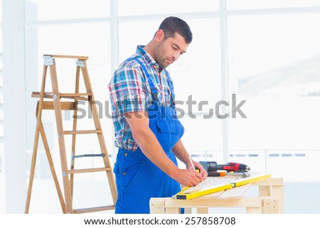 Handyman working at workbench in bright office
