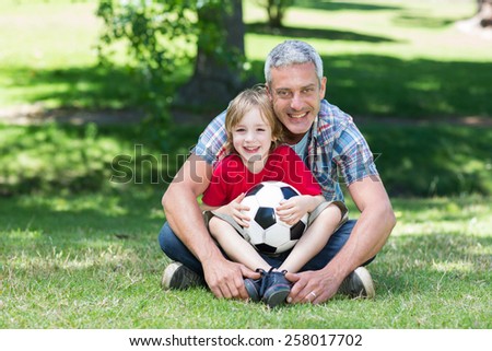 Happy father with his son at the park on a sunny day