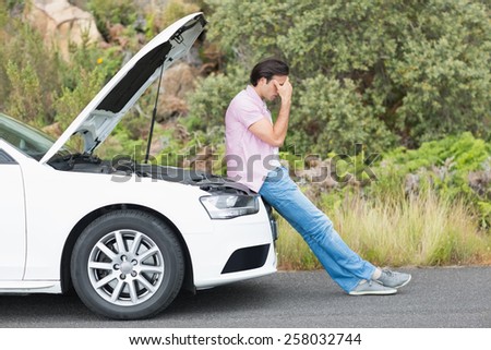 Desperate man after a car breakdown at the side of the road