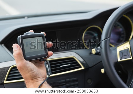Man using satellite navigation system in his car