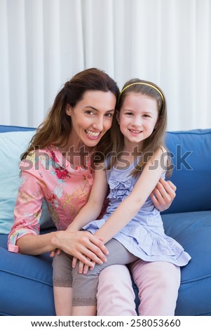 Mother and daughter on the couch at home in the living room