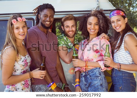 Happy hipsters smiling at camera at a music festival