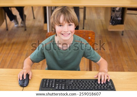 Cute pupil in computer class at the elementary school