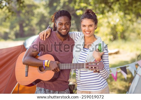 Happy hipsters having fun on campsite at a music festival