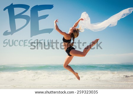 Fit blonde jumping gracefully with scarf on the beach against be sucessful