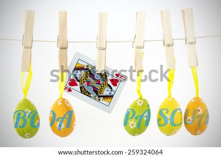 boa pascua against easter eggs hanging from a line with queen of hearts