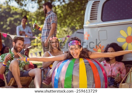 Happy hipsters having fun on campsite at a music festival