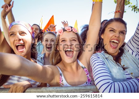 Excited young people singing along at a music festival