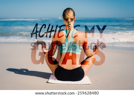 Fit woman sitting on the beach in lotus pose against achieve my goals