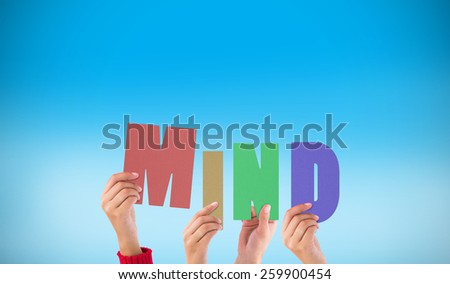 Hands holding up mind against blue background with vignette